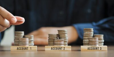 Businessman,Hand,Stacking,Coins,For,Finance,Investment,Management,By,Portfolio